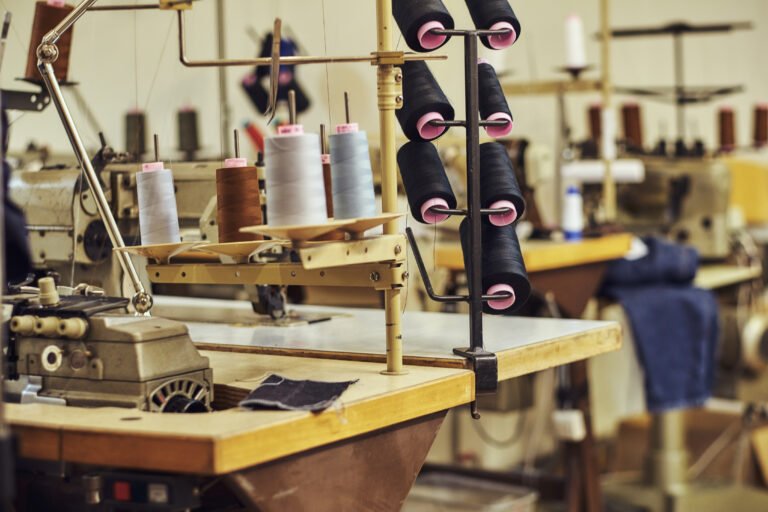 Close-up image of a lot of coils with a threads at the sewing workshop.